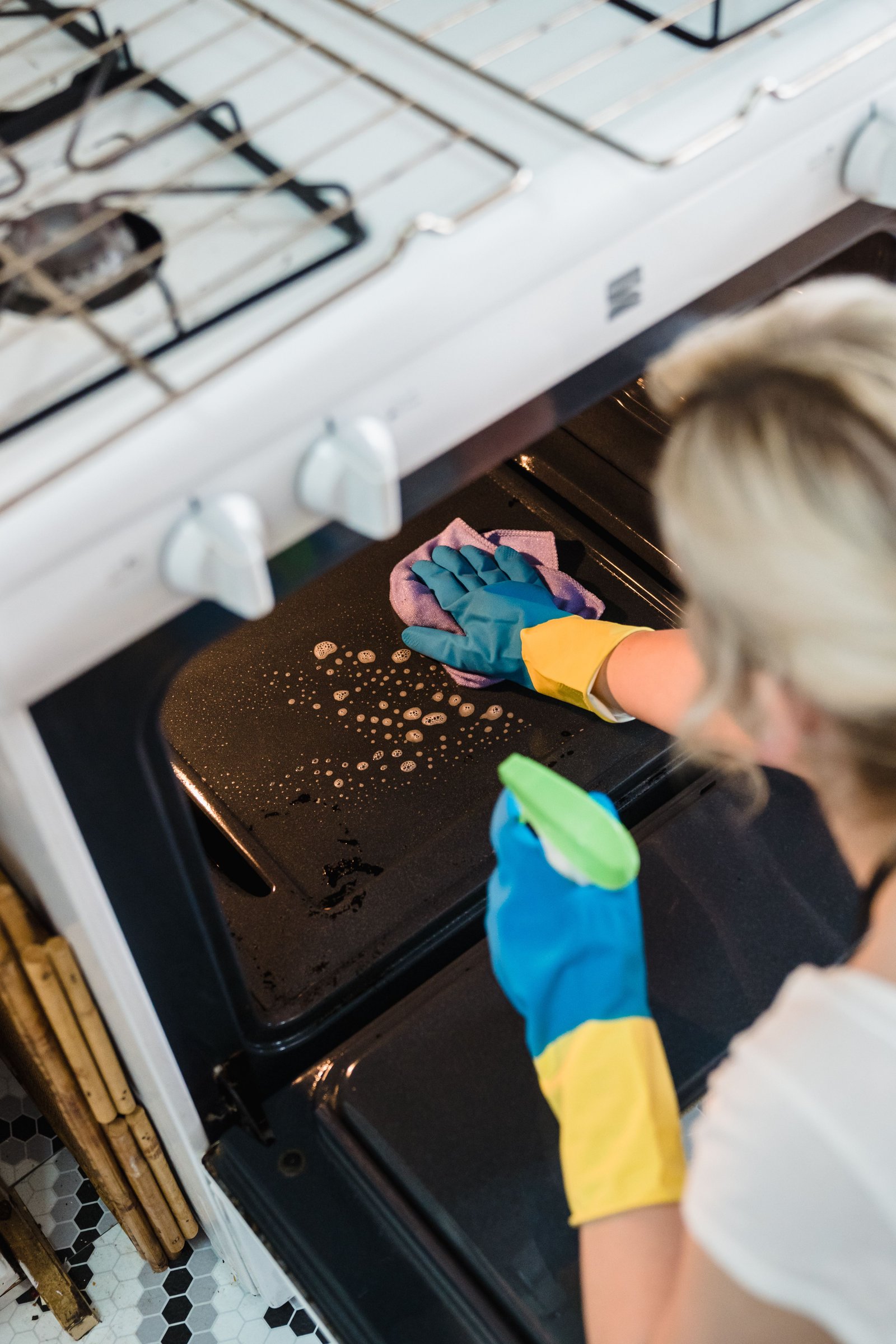 Scrubbing oven grates during a deep clean