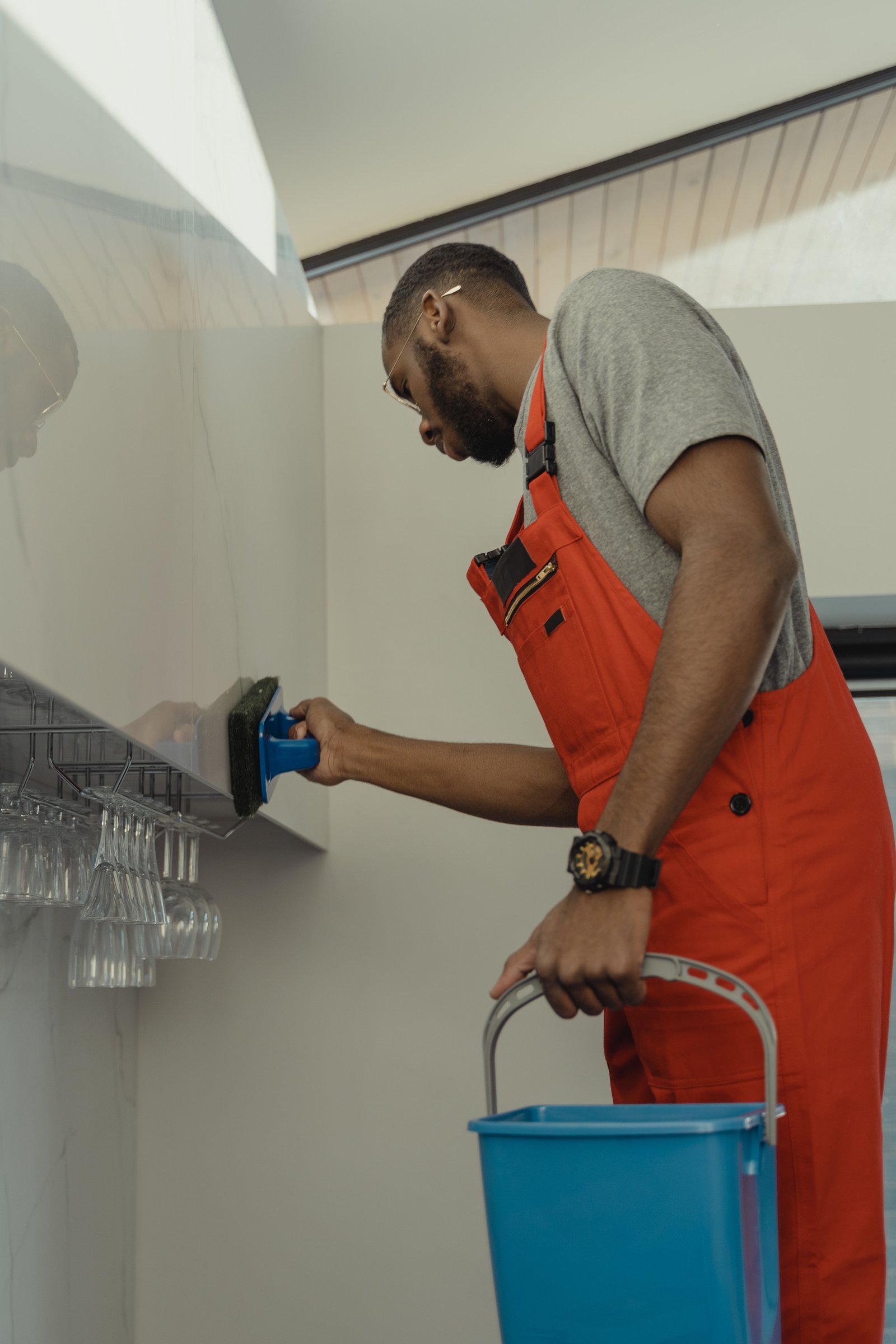 Cleaner thoroughly wiping down a wall during a deep clean