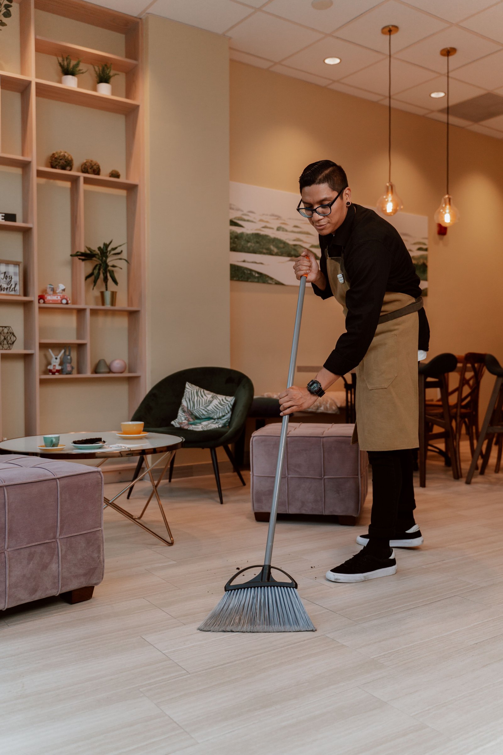 Sparkle & Co cleaner mopping a bright, open living space